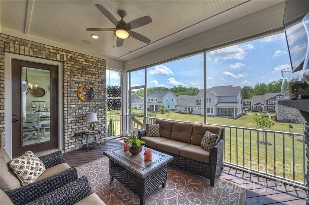 2557 Hidden Shoals Road Fort Mill, SC 29708 - Photo 28 of 30 a living room with furniture and a floor to ceiling window