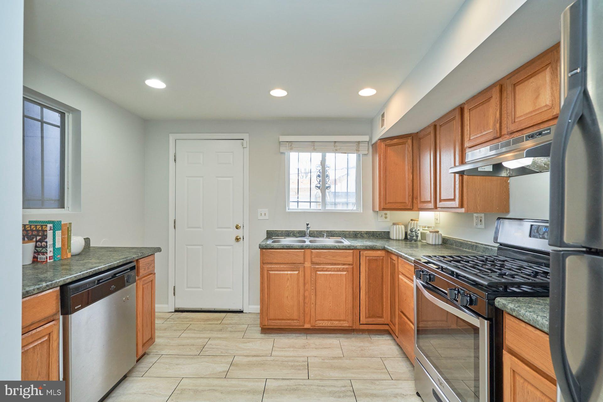 1313 K Street Southeast Washington, DC 20003 - Photo 14 of 48 a kitchen with granite countertop a sink stove and cabinets