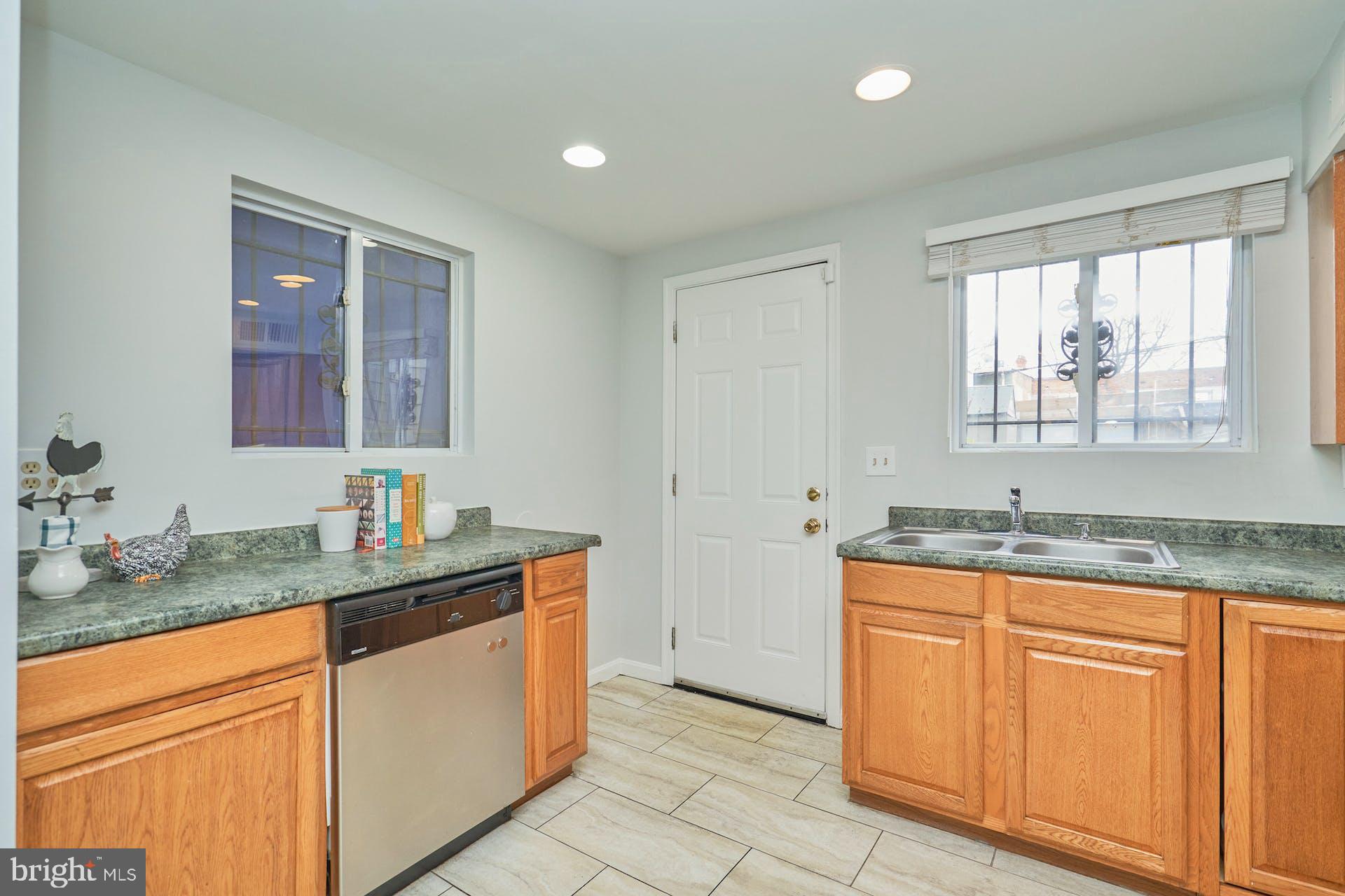 1313 K Street Southeast Washington, DC 20003 - Photo 15 of 48 a kitchen with granite countertop a sink and cabinets
