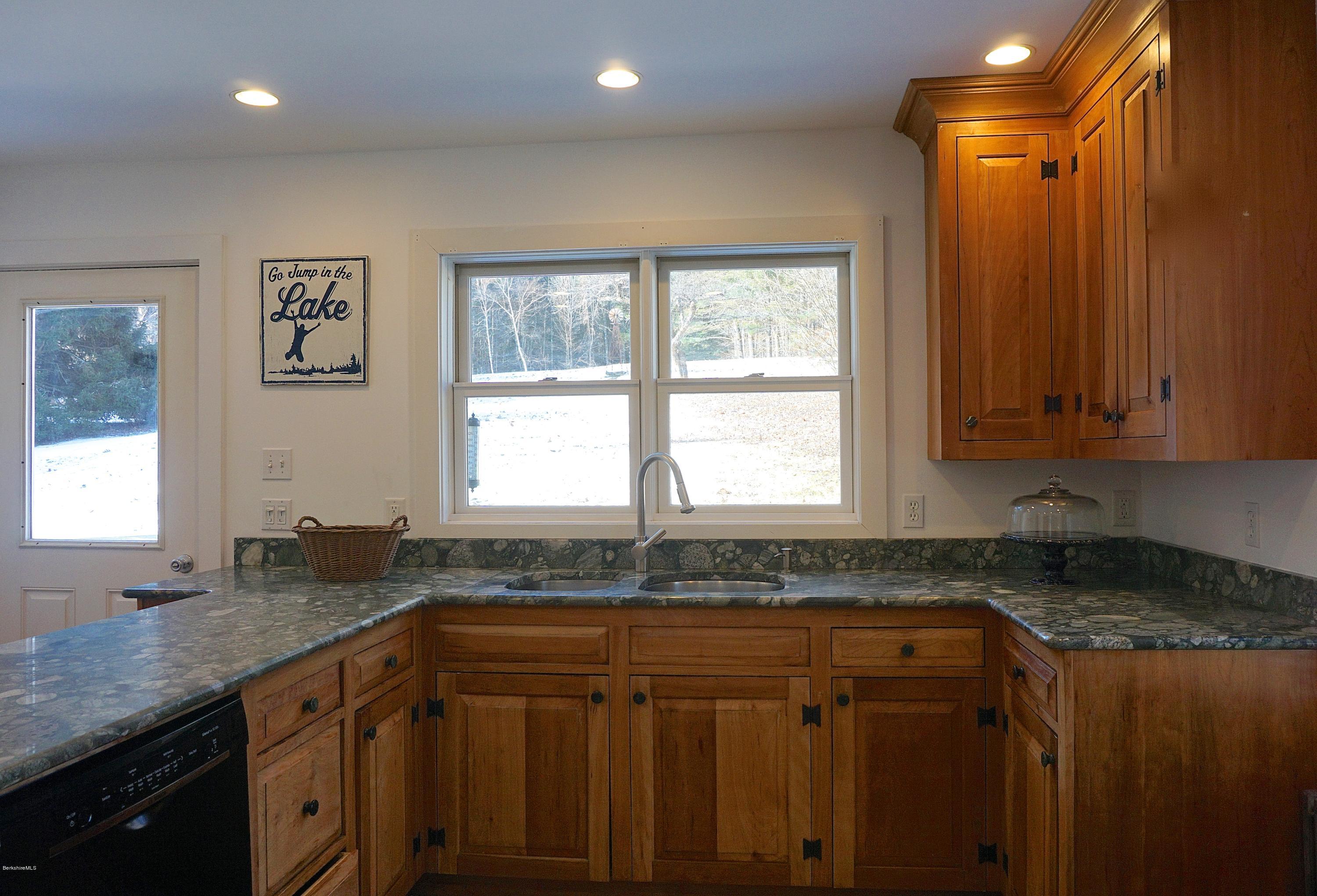 38 Sandisfield Road Monterey, MA 01245 - Photo 11 of 25 a kitchen with granite countertop cabinets stainless steel appliances a sink and a window