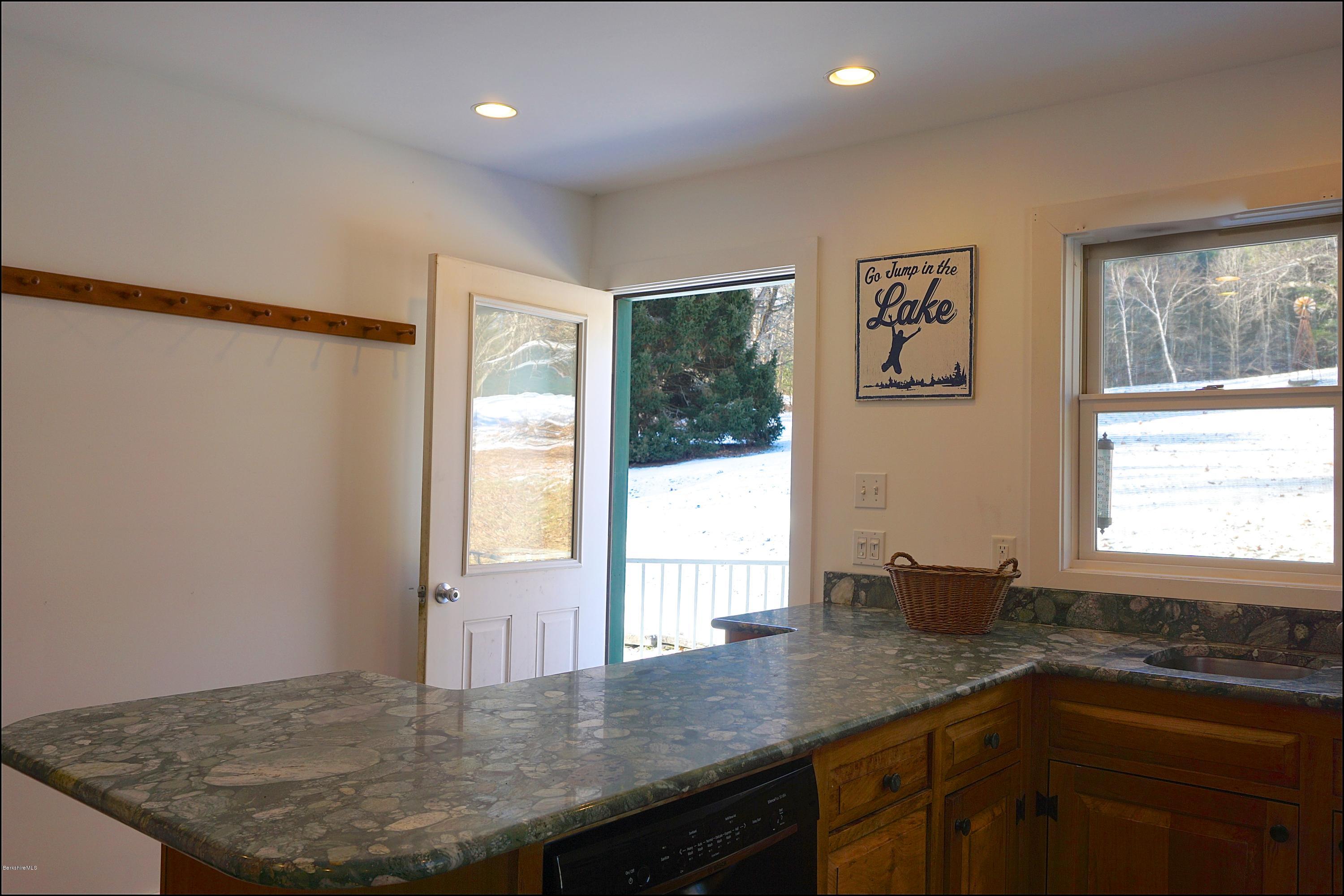 38 Sandisfield Road Monterey, MA 01245 - Photo 22 of 25 a kitchen with stainless steel appliances granite countertop a sink a window and a counter top space