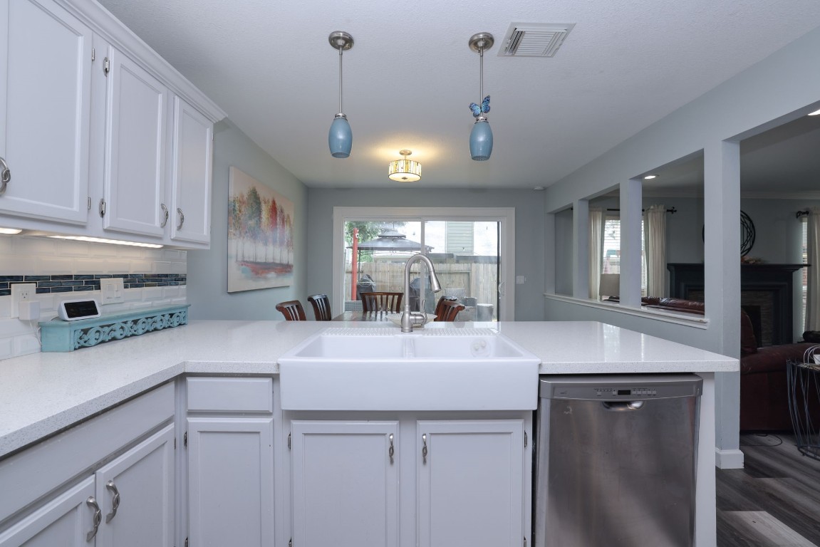 8827 Stoney Bend Drive Spring, TX 77379 - Photo 15 of 39 a kitchen with stainless steel appliances granite countertop a sink a refrigerator and a view of living room