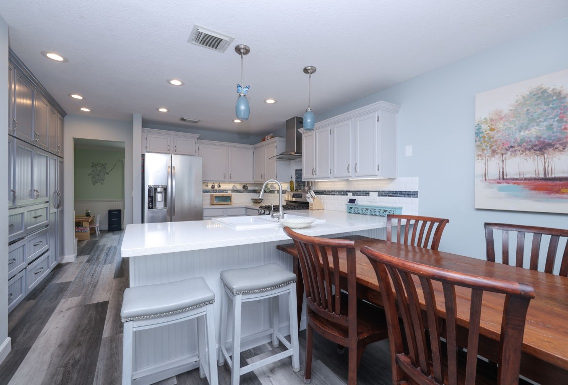 8827 Stoney Bend Drive Spring, TX 77379 - Photo 17 of 39 a large kitchen with kitchen island a dining table and chairs