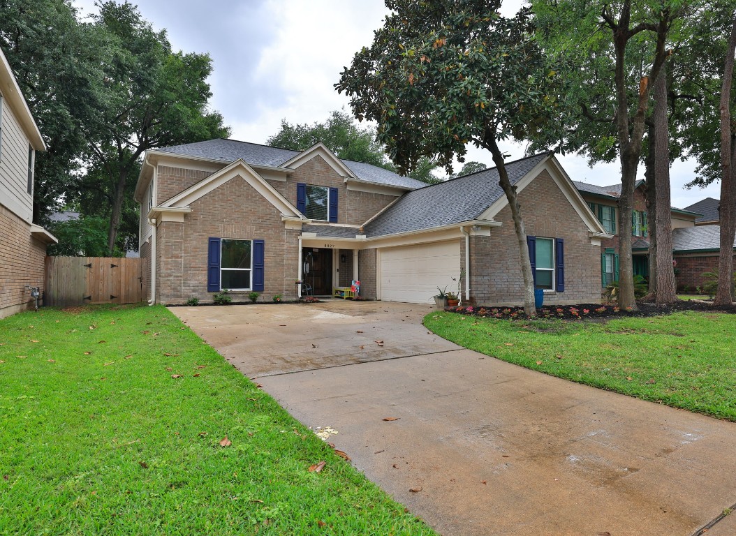 8827 Stoney Bend Drive Spring, TX 77379 - Photo 2 of 39 a front view of a house with a yard and garage