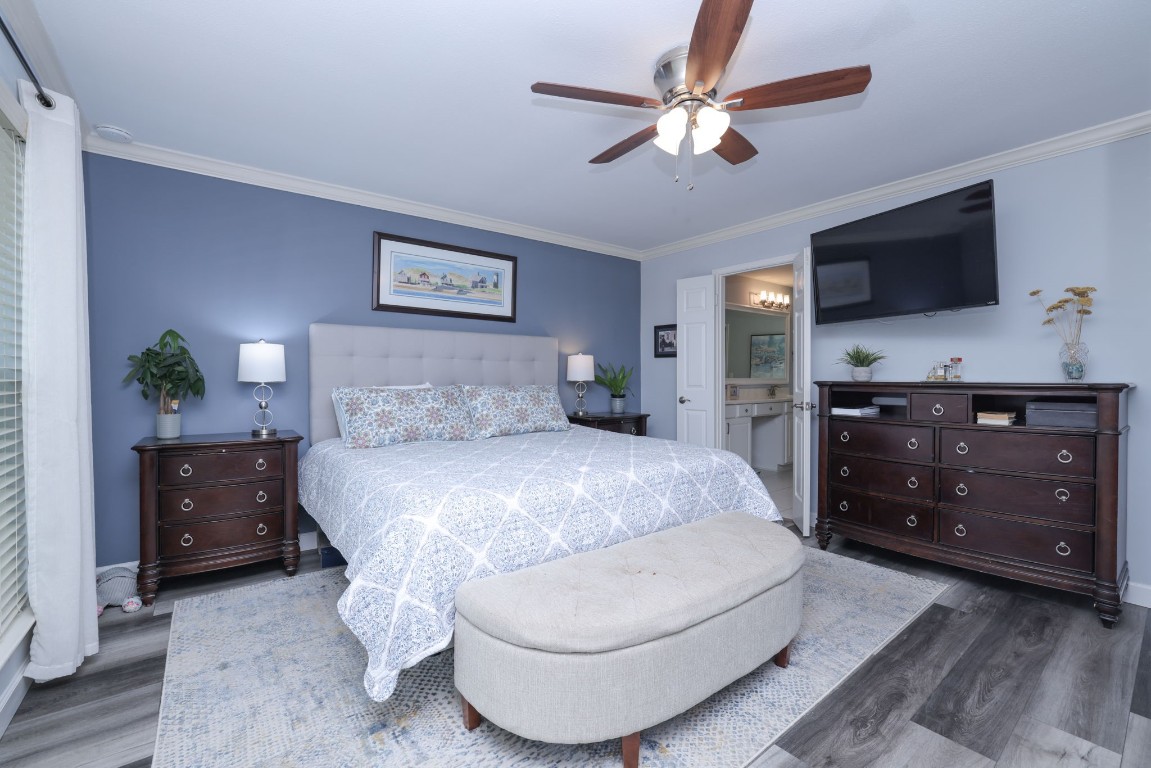 8827 Stoney Bend Drive Spring, TX 77379 - Photo 22 of 39 a bedroom with a bed and a dresser with a flat tv screen