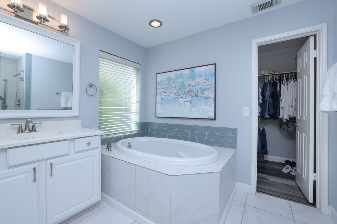 8827 Stoney Bend Drive Spring, TX 77379 - Photo 26 of 39 a bathroom with a sink a toilet and shower