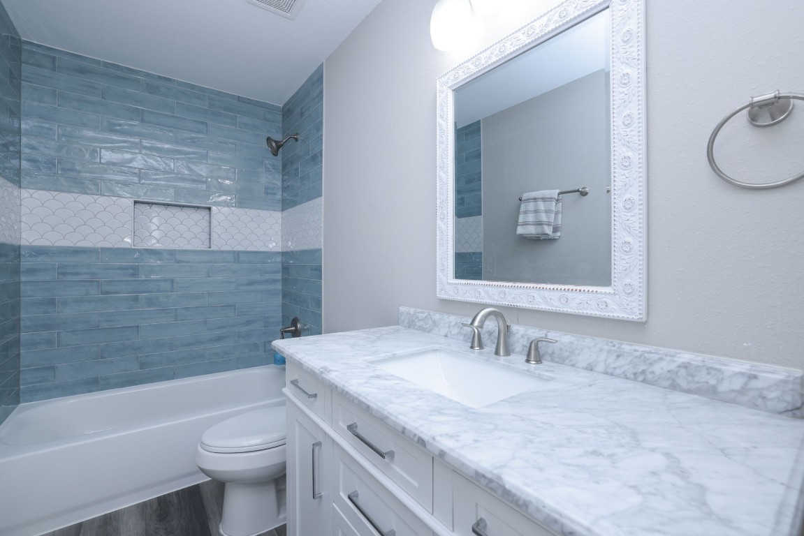 8827 Stoney Bend Drive Spring, TX 77379 - Photo 29 of 39 a bathroom with a granite countertop sink toilet and shower