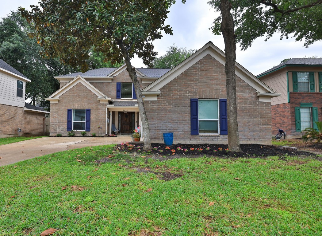 8827 Stoney Bend Drive Spring, TX 77379 - Photo 3 of 39 a front view of a house with a garden