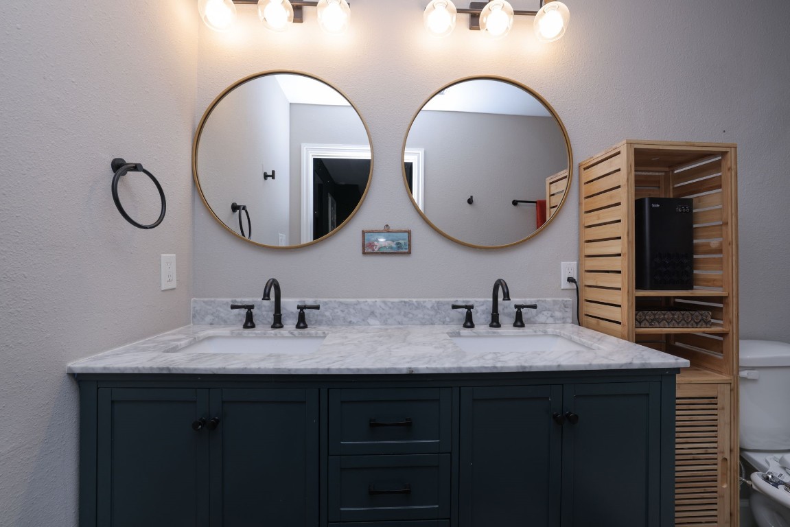 8827 Stoney Bend Drive Spring, TX 77379 - Photo 33 of 39 a bathroom with a double vanity sink and a mirror