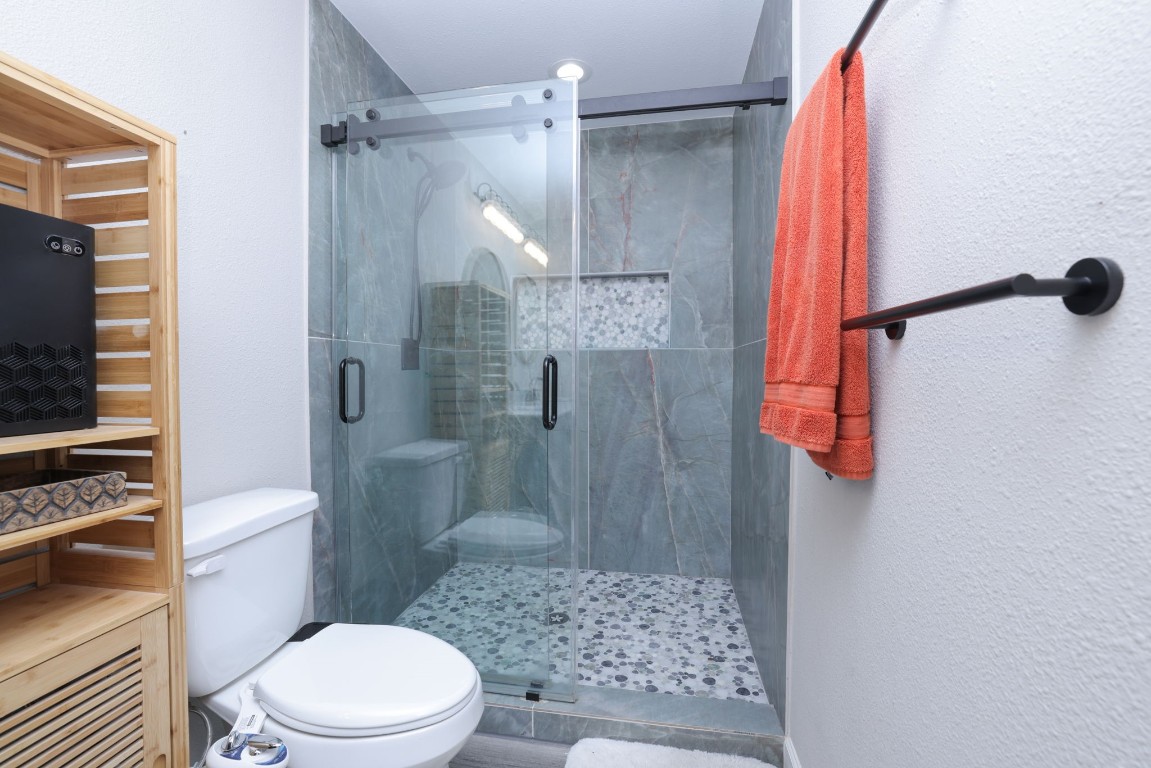 8827 Stoney Bend Drive Spring, TX 77379 - Photo 34 of 39 a bathroom with a shower and a toilet