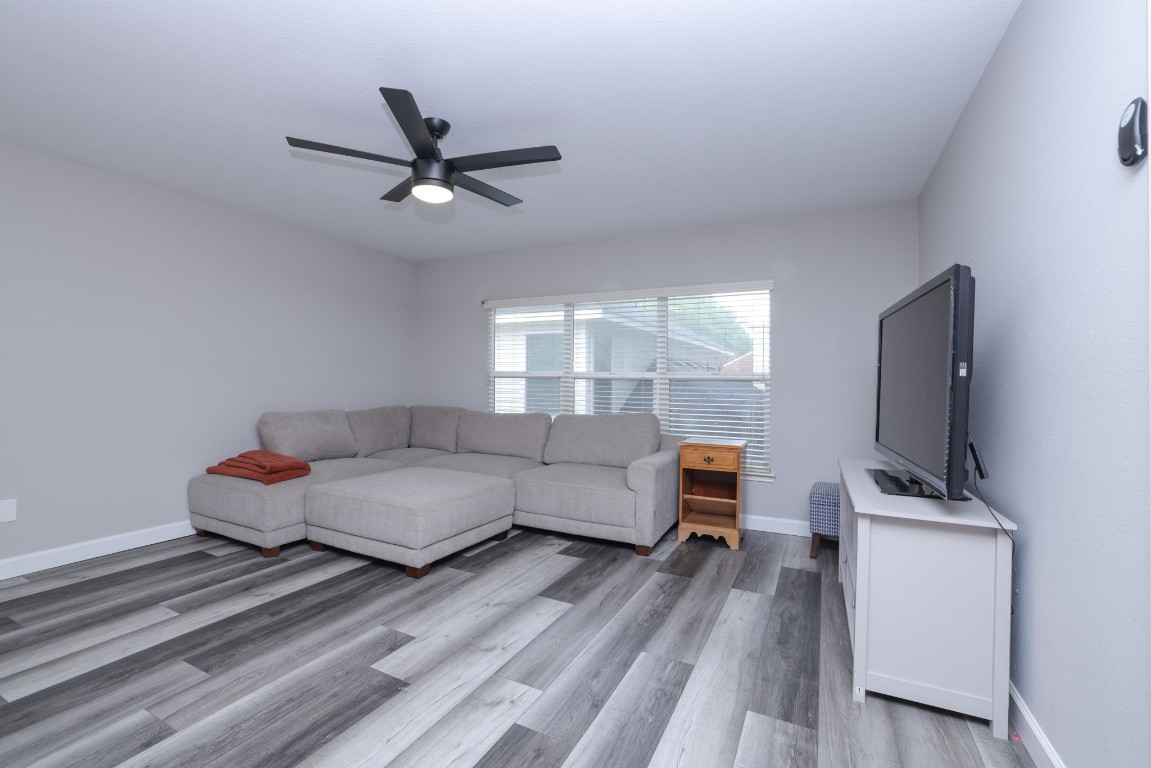 8827 Stoney Bend Drive Spring, TX 77379 - Photo 35 of 39 a living room with furniture and a flat screen tv