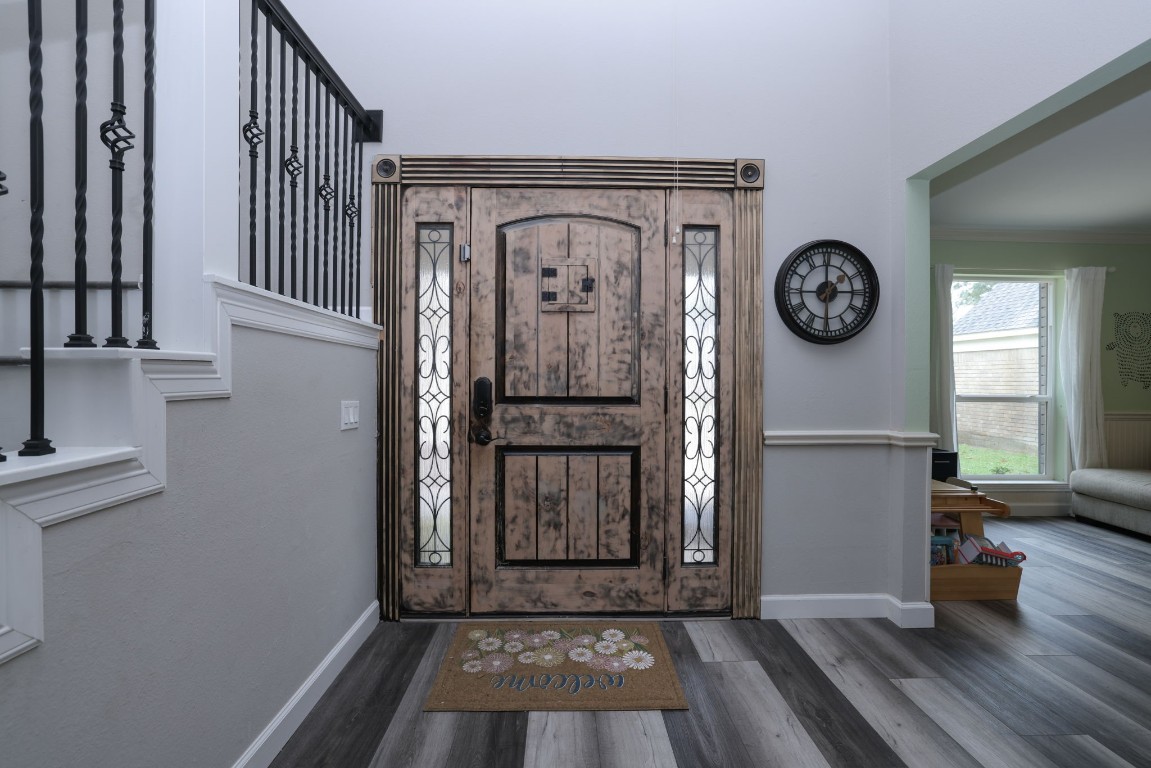 8827 Stoney Bend Drive Spring, TX 77379 - Photo 6 of 39 a view of a hallway with wooden floor