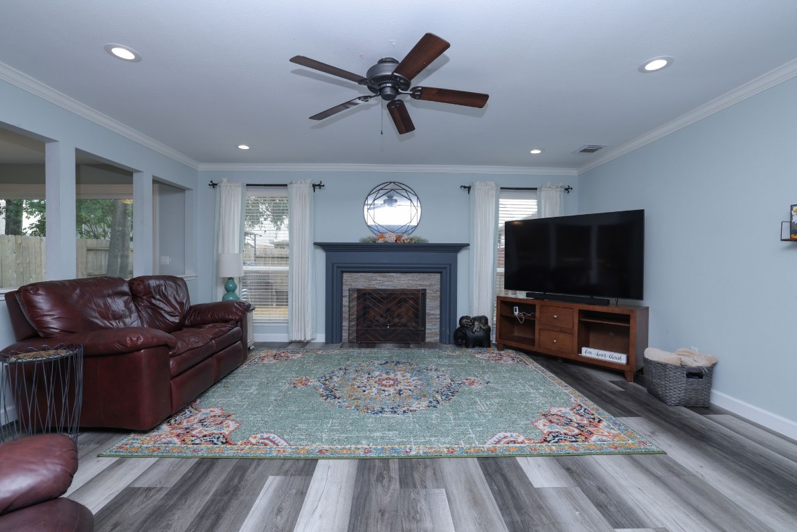 8827 Stoney Bend Drive Spring, TX 77379 - Photo 9 of 39 a living room with furniture a flat screen tv and a fireplace