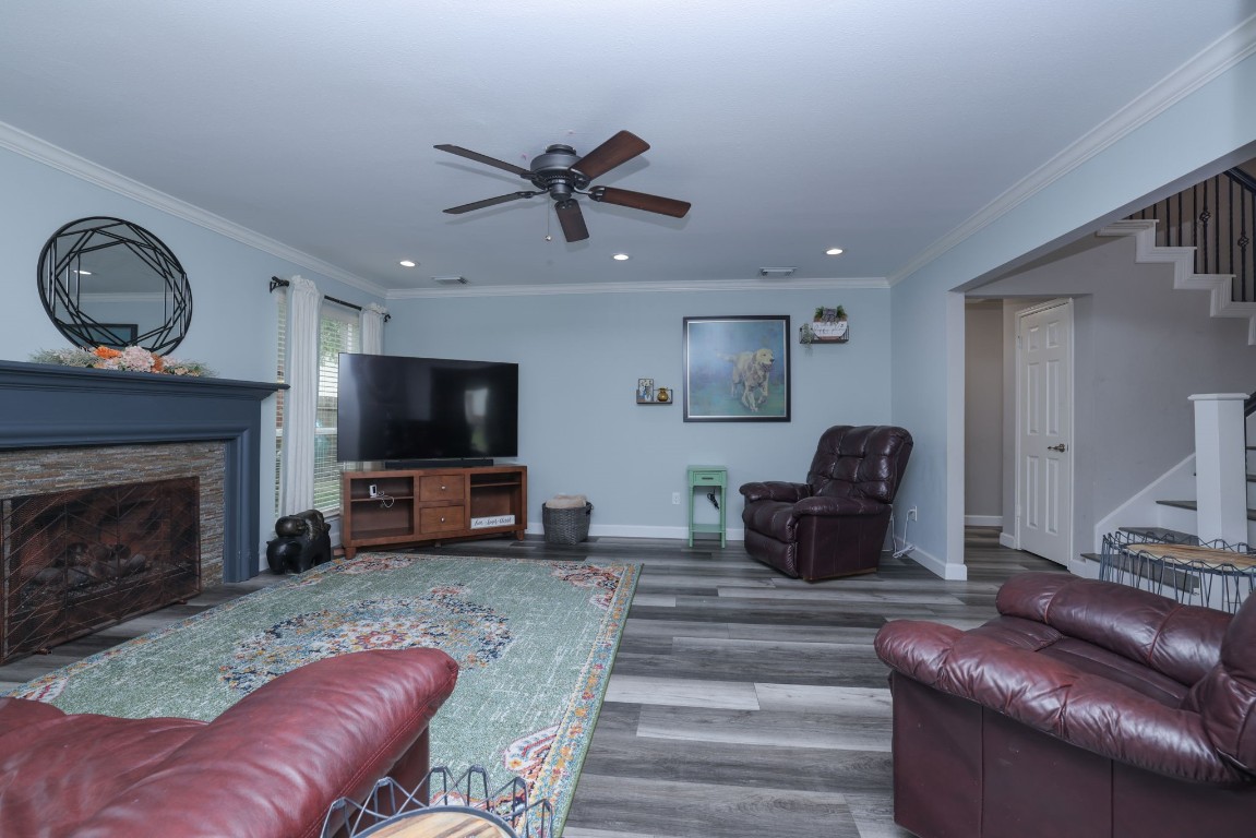 8827 Stoney Bend Drive Spring, TX 77379 - Photo 10 of 39 a living room with furniture a flat screen tv and a fireplace