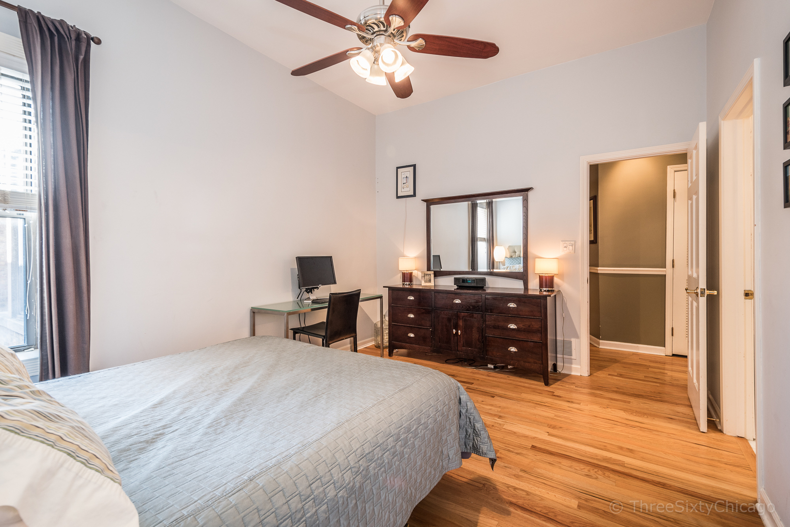 4028 North Sheridan Road, Unit 3 Chicago, IL 60613 - Photo 15 of 25 a bedroom with a bed and wooden floor