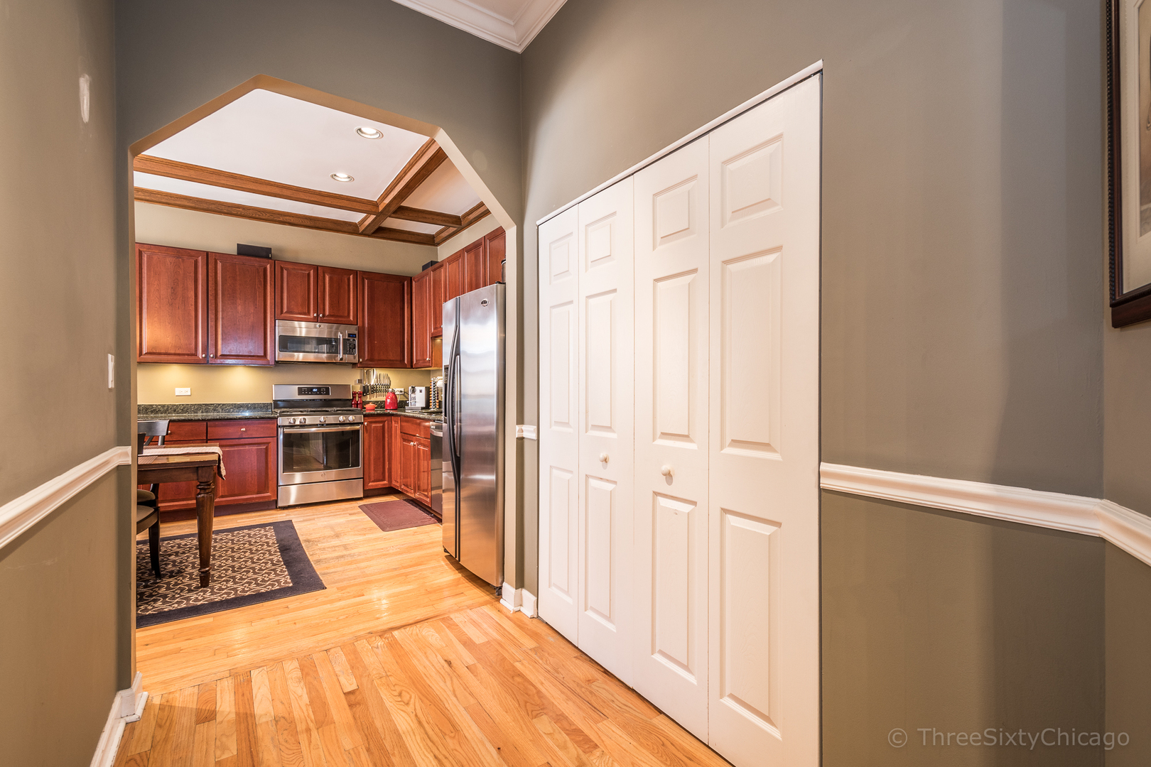 4028 North Sheridan Road, Unit 3 Chicago, IL 60613 - Photo 24 of 25 a kitchen with stainless steel appliances a refrigerator and wooden cabinets