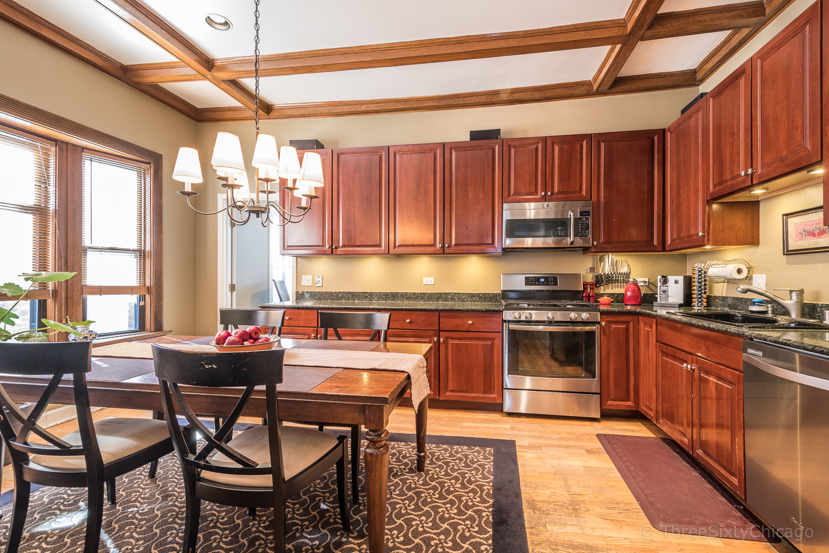 4028 North Sheridan Road, Unit 3 Chicago, IL 60613 - Photo 6 of 25 a kitchen with stainless steel appliances kitchen island granite countertop a sink and cabinets