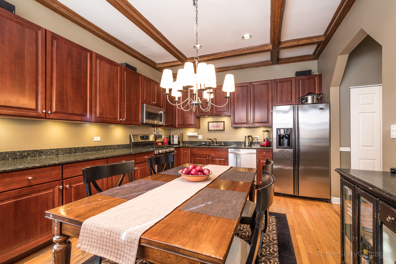 4028 North Sheridan Road, Unit 3 Chicago, IL 60613 - Photo 9 of 25 a kitchen with stainless steel appliances granite countertop a sink window and refrigerator
