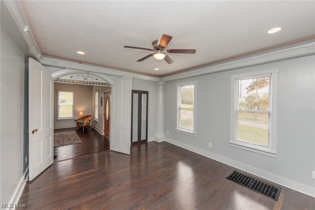 2551 Reimer Road Wadsworth, OH 44281 - Photo 7 of 35 Unfurnished room with dark hardwood flooring, ceiling fan, and ornamental molding