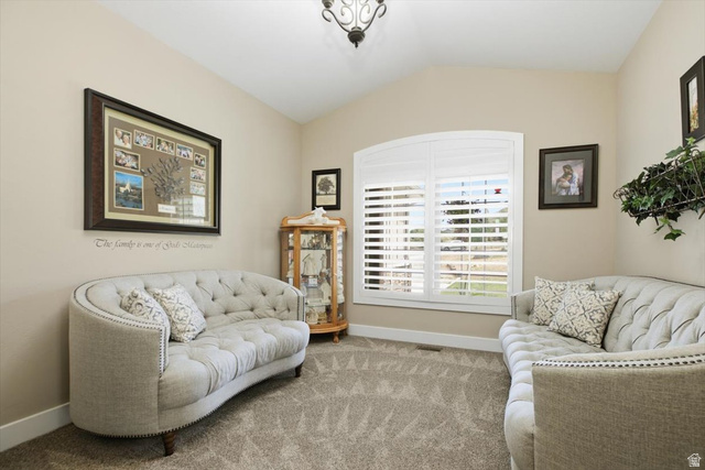 3123 East Riverdale Road Preston, ID 83263 - Photo 4 of 52 Den - Vaulted ceiling room featuring light-colored wall paint, plush carpet flooring, and an arched window with white plantation shutters