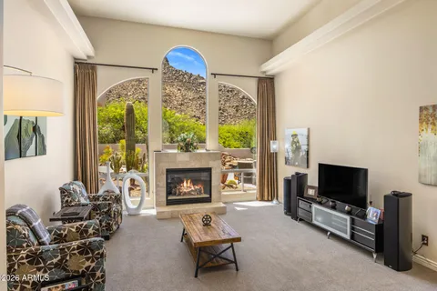 a living room with furniture a flat screen tv and a fireplace