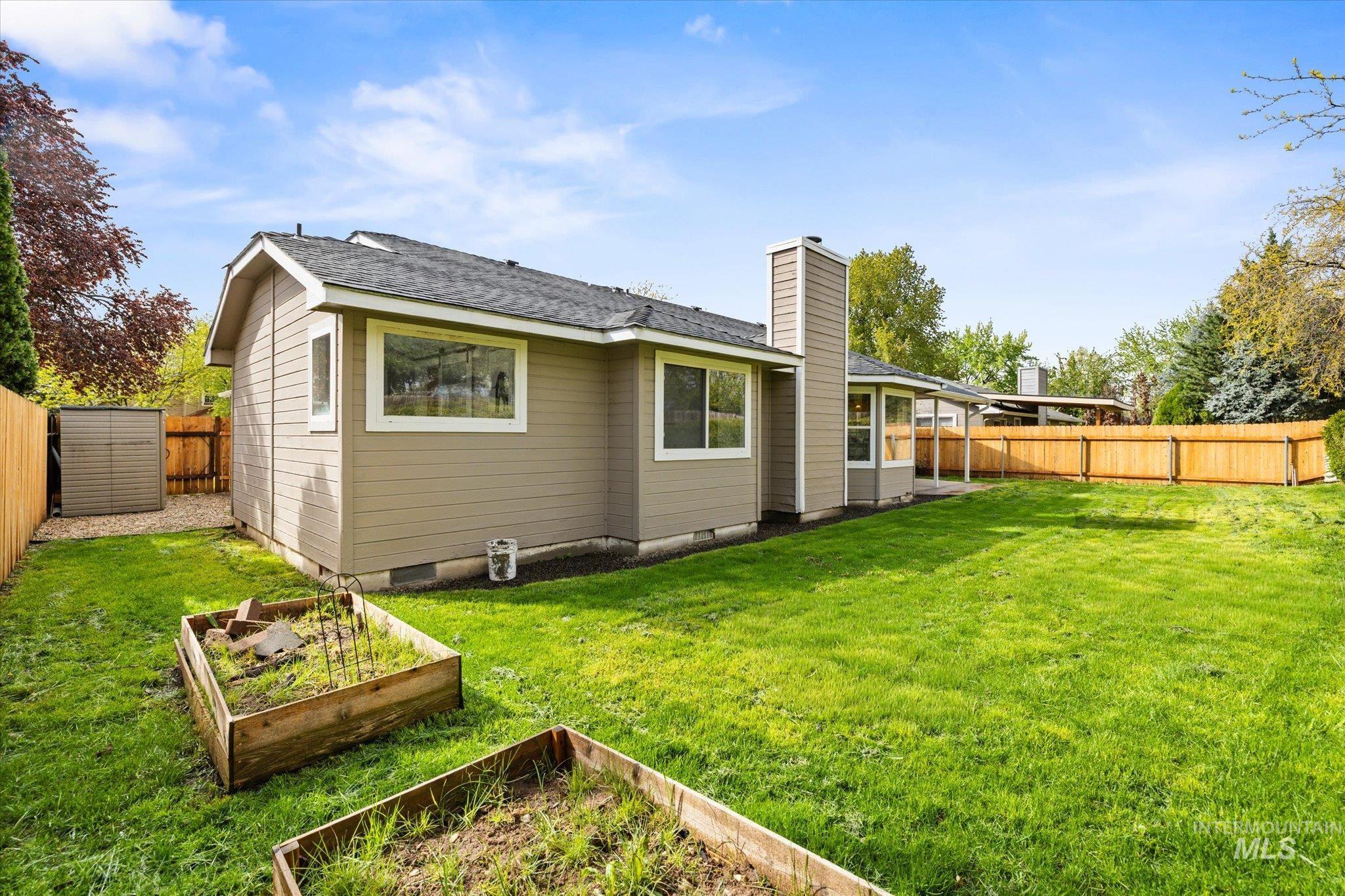 2250 North Amethyst Avenue Meridian, ID 83646 - Photo 46 of 50 Back of house featuring a fenced backyard, a garden, a chimney, a shingled roof, and crawl space