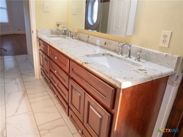 a bathroom with a sink and a mirror