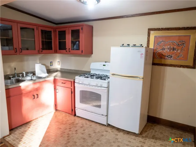 a kitchen with stainless steel appliances granite countertop a stove a refrigerator and a microwave