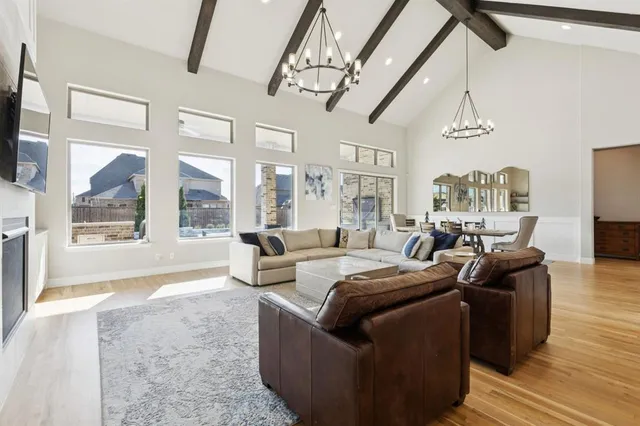 a living room with furniture and a chandelier