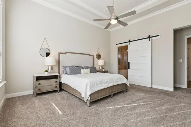 a bedroom with a bed and a ceiling fan