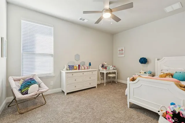 a room that has a dresser and a chair in it