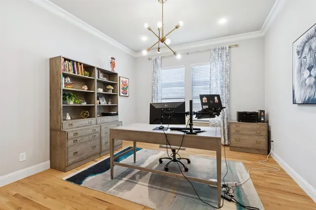 a view of a workspace with furniture and a window