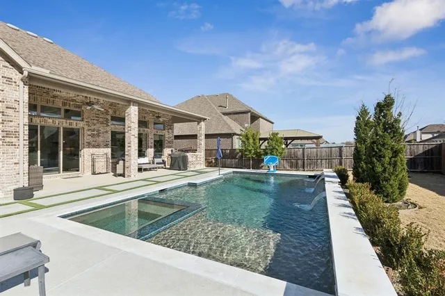 a view of a house with backyard porch and sitting area