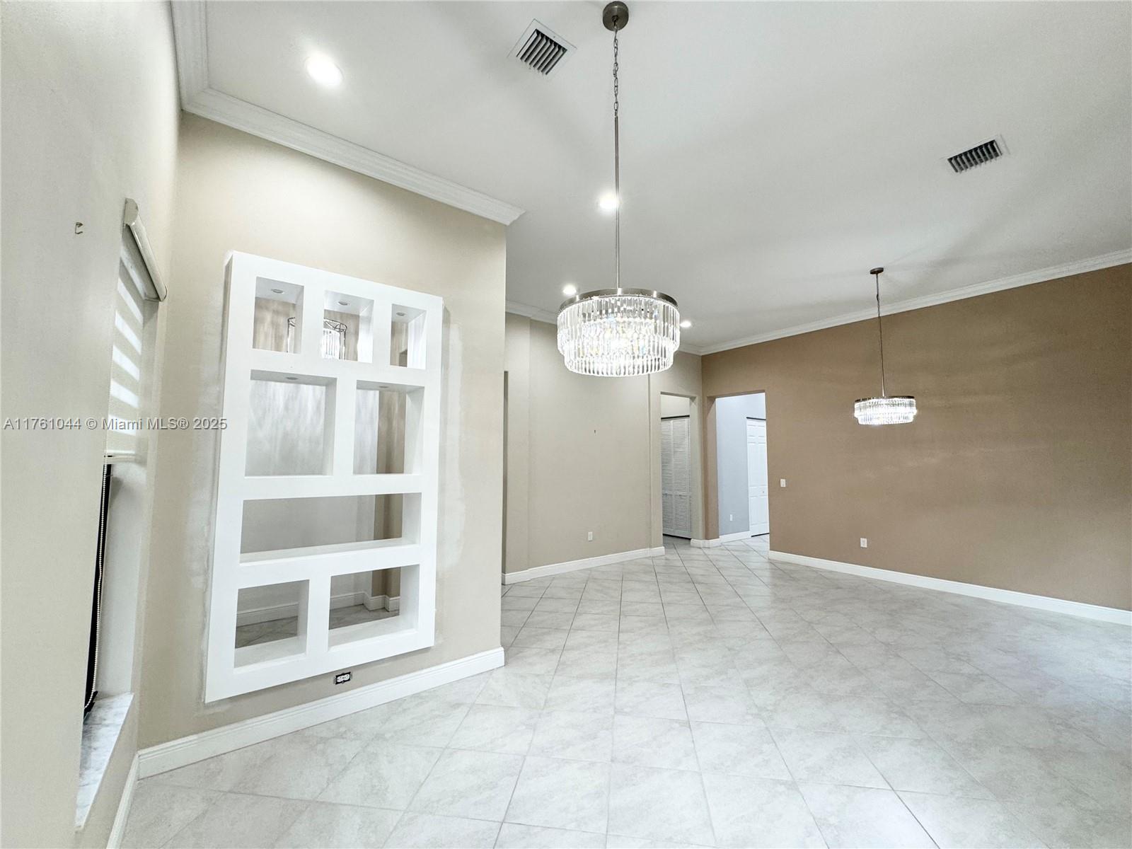 5008 Salerno Street Ave Maria, FL 34142 - Photo 12 of 46 a view of a big room with a chandelier fan and windows