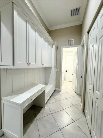 a white bath tub sitting next to a white toilet and a window