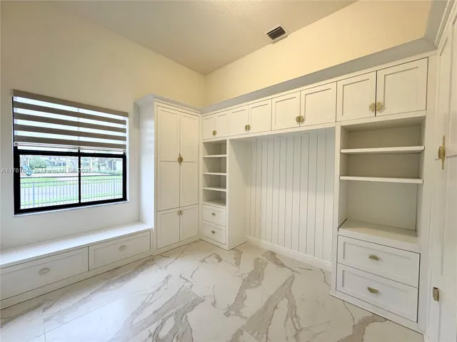 an empty room with wooden floor and window
