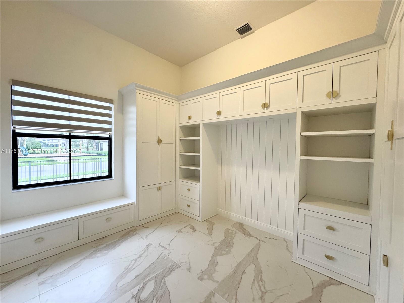 5008 Salerno Street Ave Maria, FL 34142 - Photo 18 of 46 a view of an empty room with cabinet and stairs