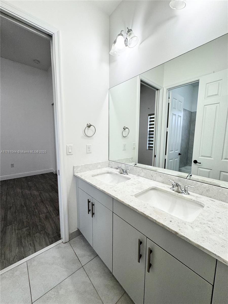 5008 Salerno Street Ave Maria, FL 34142 - Photo 19 of 46 a bathroom with a sink and a mirror