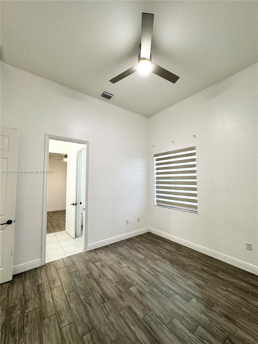 5008 Salerno Street Ave Maria, FL 34142 - Photo 20 of 46 an empty room with wooden floor and window