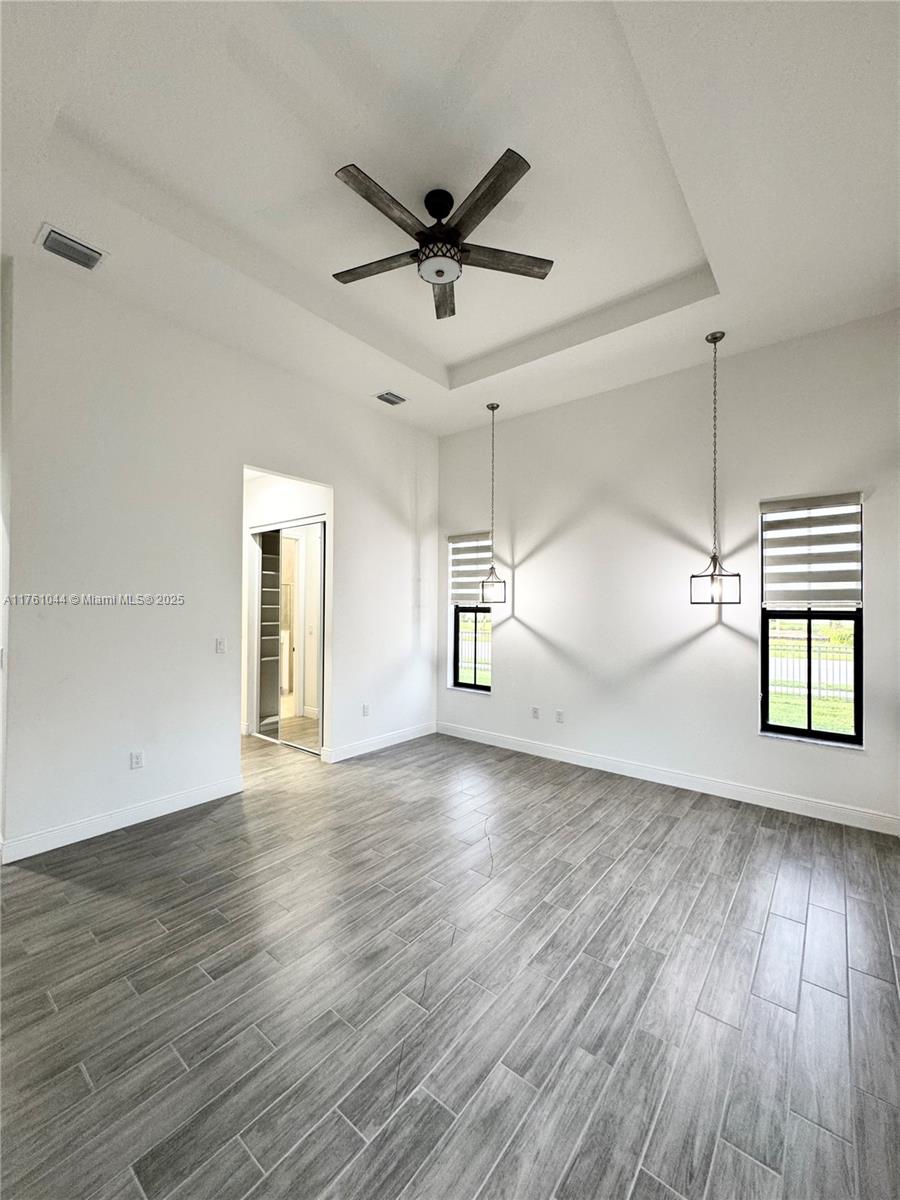 5008 Salerno Street Ave Maria, FL 34142 - Photo 21 of 46 wooden floor in an empty room with a window