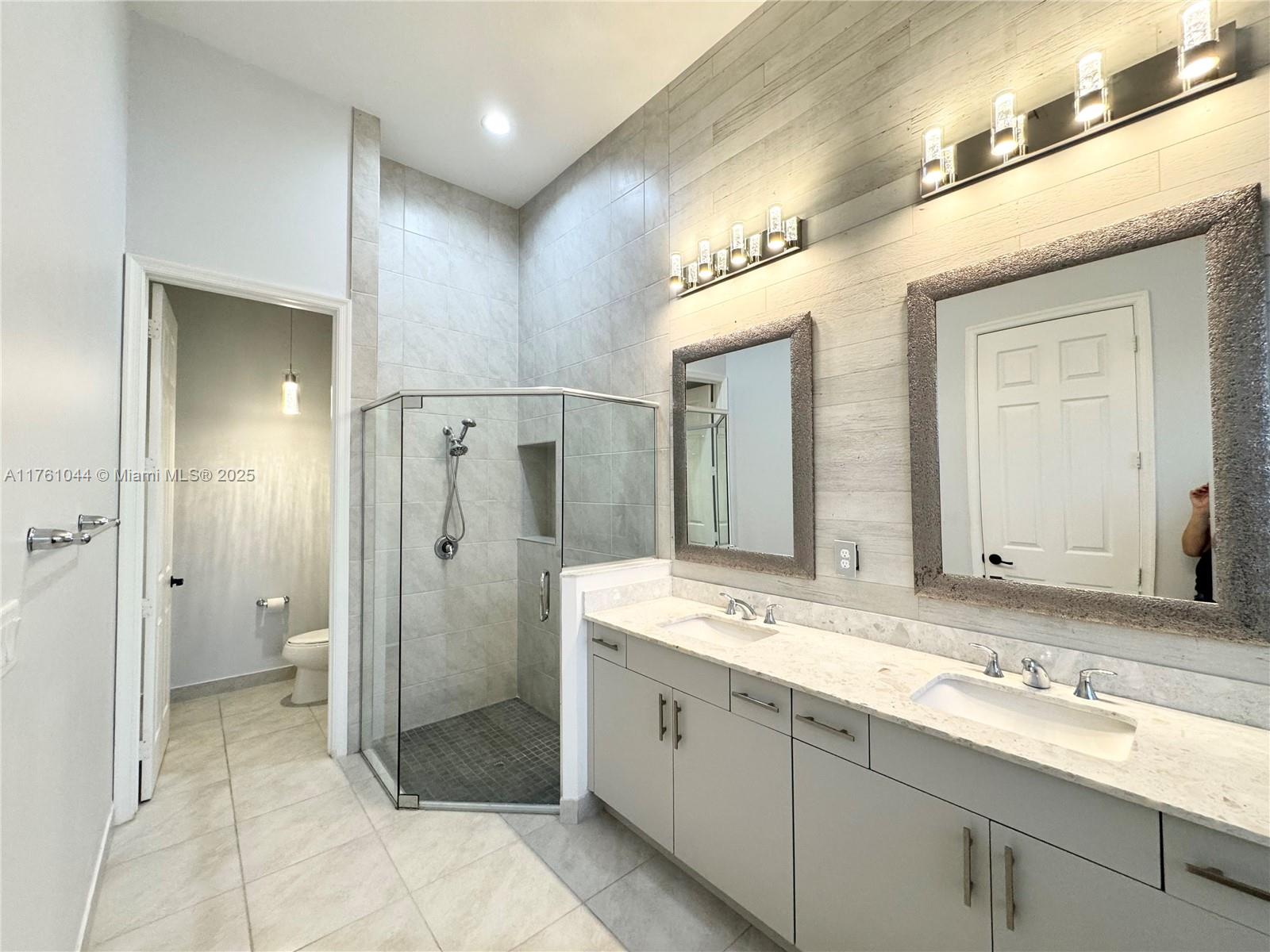 5008 Salerno Street Ave Maria, FL 34142 - Photo 25 of 46 a spacious bathroom with a shower sink and mirror