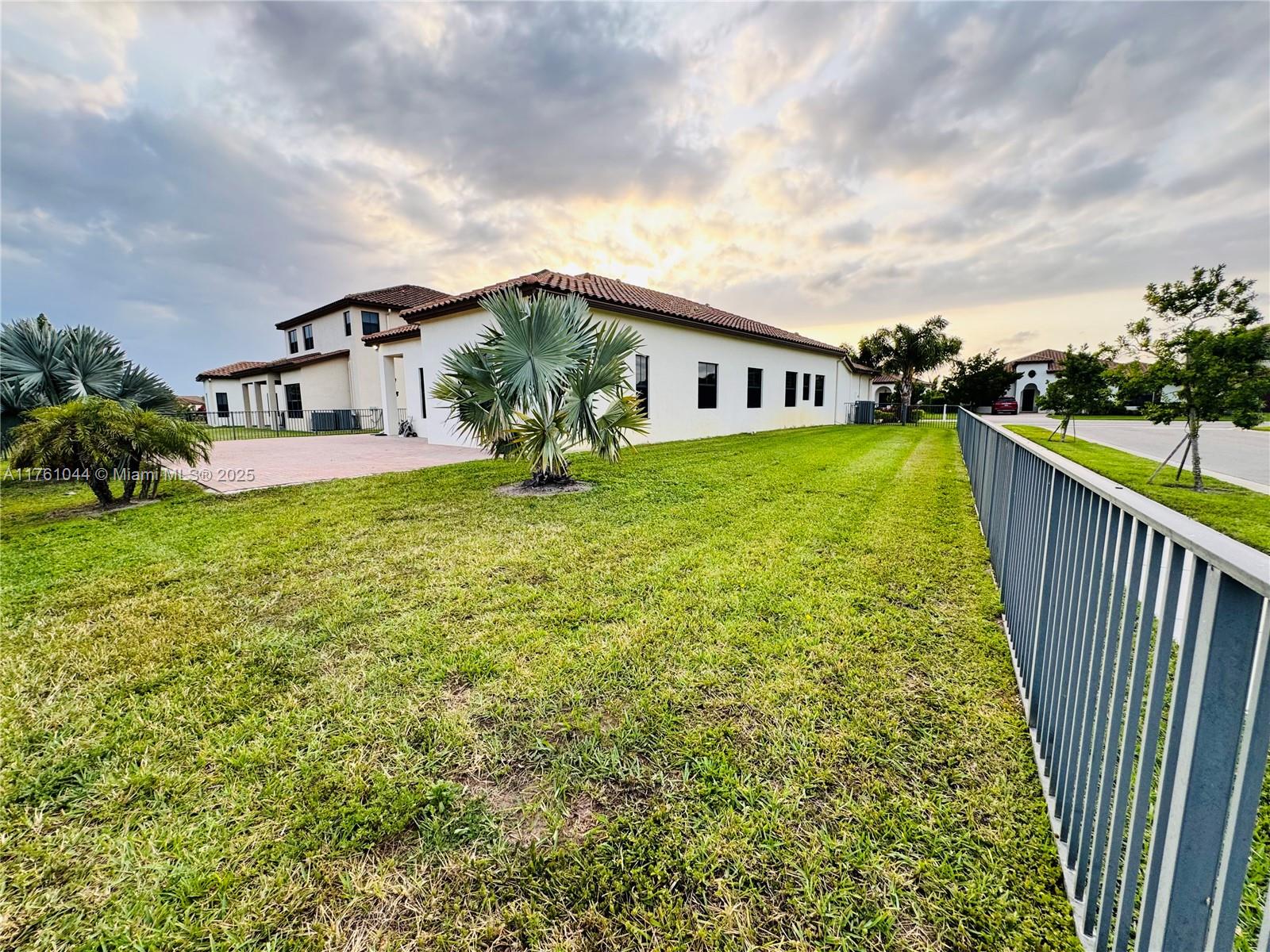 5008 Salerno Street Ave Maria, FL 34142 - Photo 27 of 46 a view of a house with backyard and garden