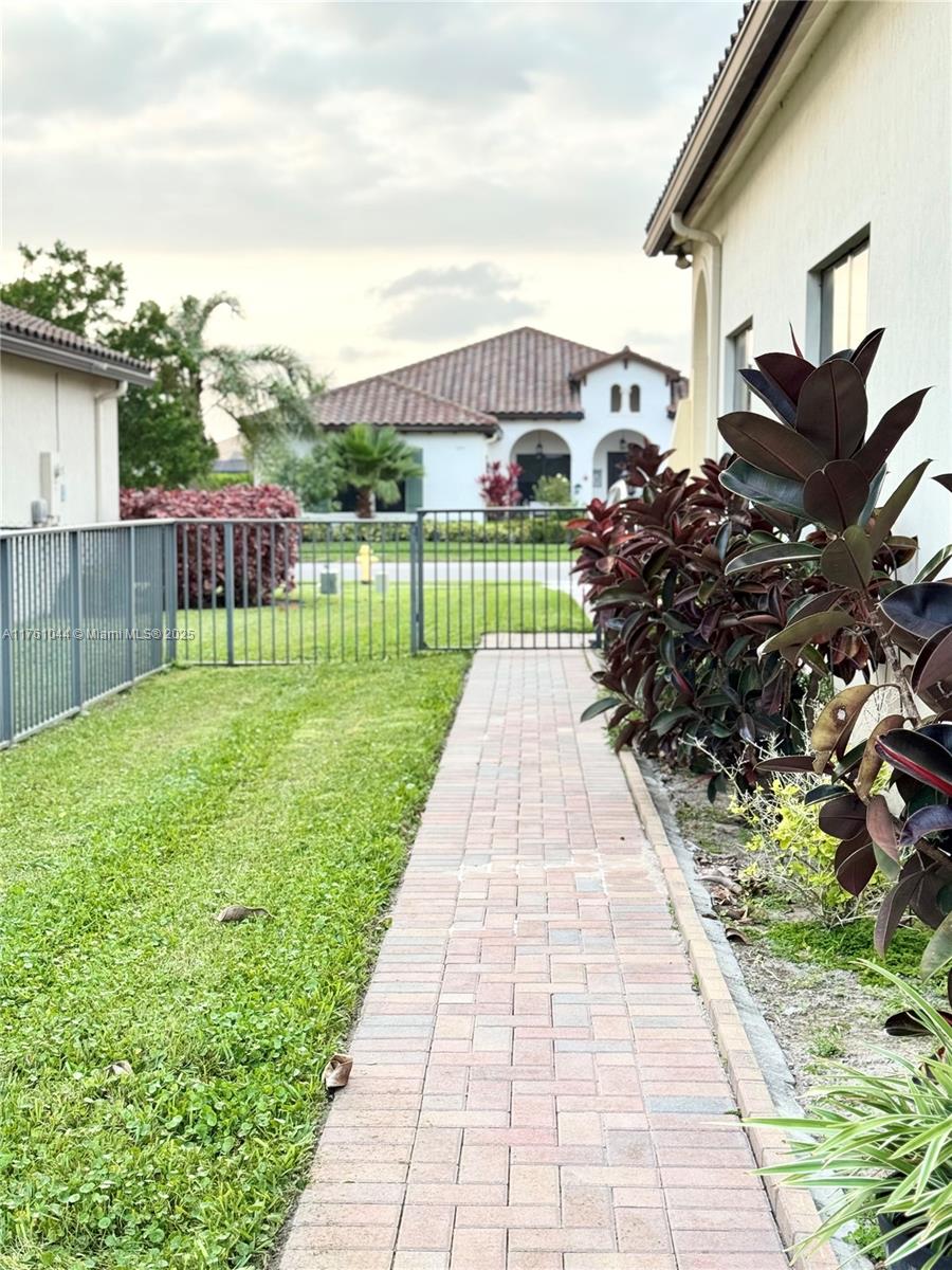5008 Salerno Street Ave Maria, FL 34142 - Photo 29 of 46 a view of a backyard with sitting area