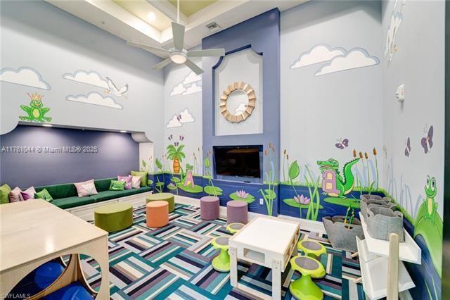 5008 Salerno Street Ave Maria, FL 34142 - Photo 35 of 46 a living room with patio a fireplace and a potted plant