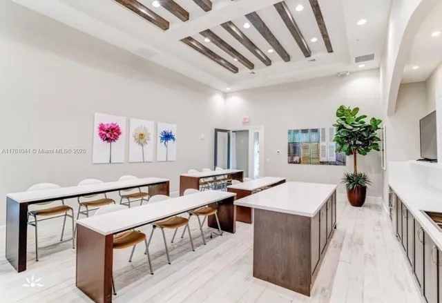 a large kitchen with a table and chairs