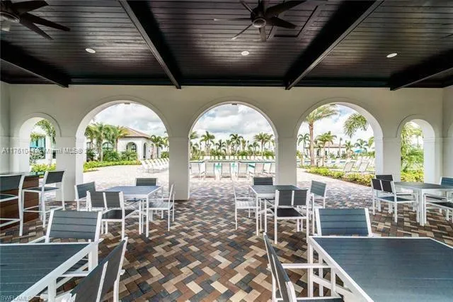 a very nice looking dining room with a large window and a fireplace