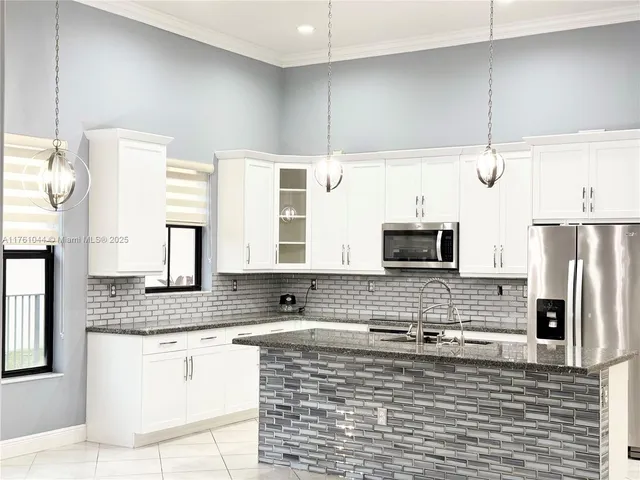a kitchen with stainless steel appliances a refrigerator and a sink