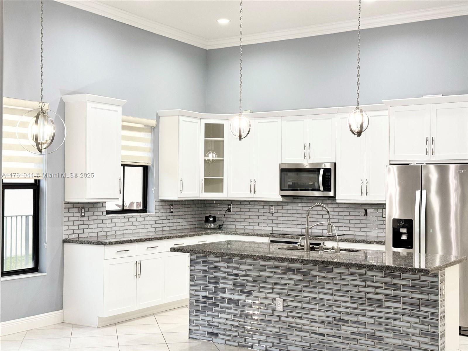 5008 Salerno Street Ave Maria, FL 34142 - Photo 4 of 46 a kitchen with stainless steel appliances a refrigerator and a sink