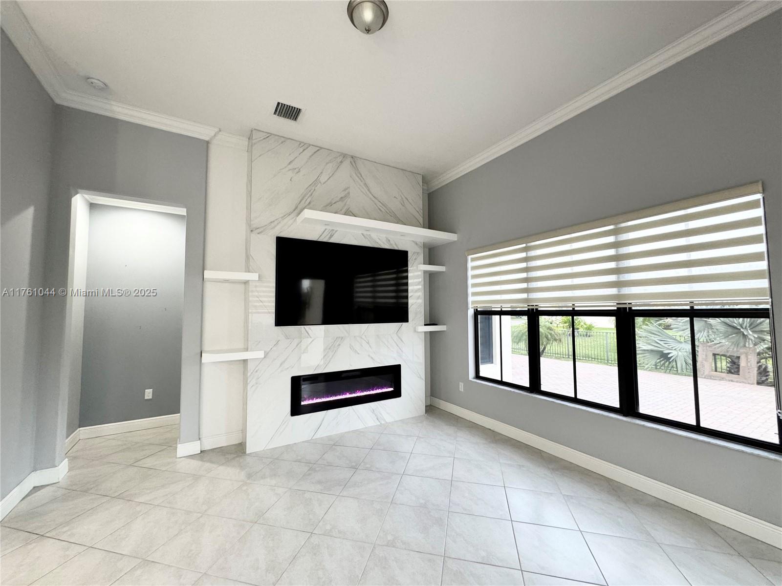 5008 Salerno Street Ave Maria, FL 34142 - Photo 7 of 46 a view of livingroom with furniture flat screen tv and refrigerator