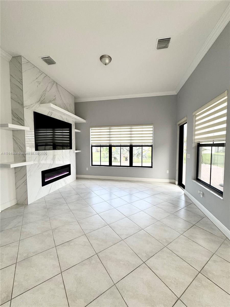 5008 Salerno Street Ave Maria, FL 34142 - Photo 8 of 46 a view of an empty room with kitchen and window